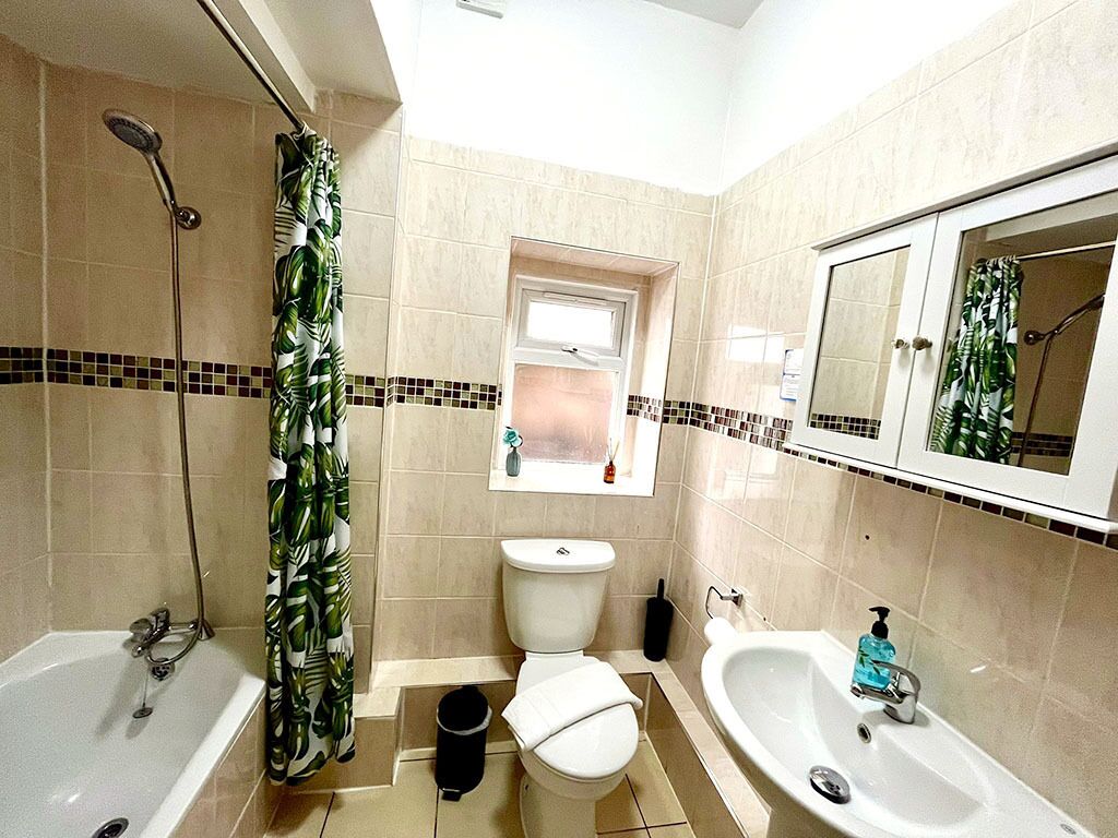 A bathroom with a bathtub, a shower, a toilet, and a sink.