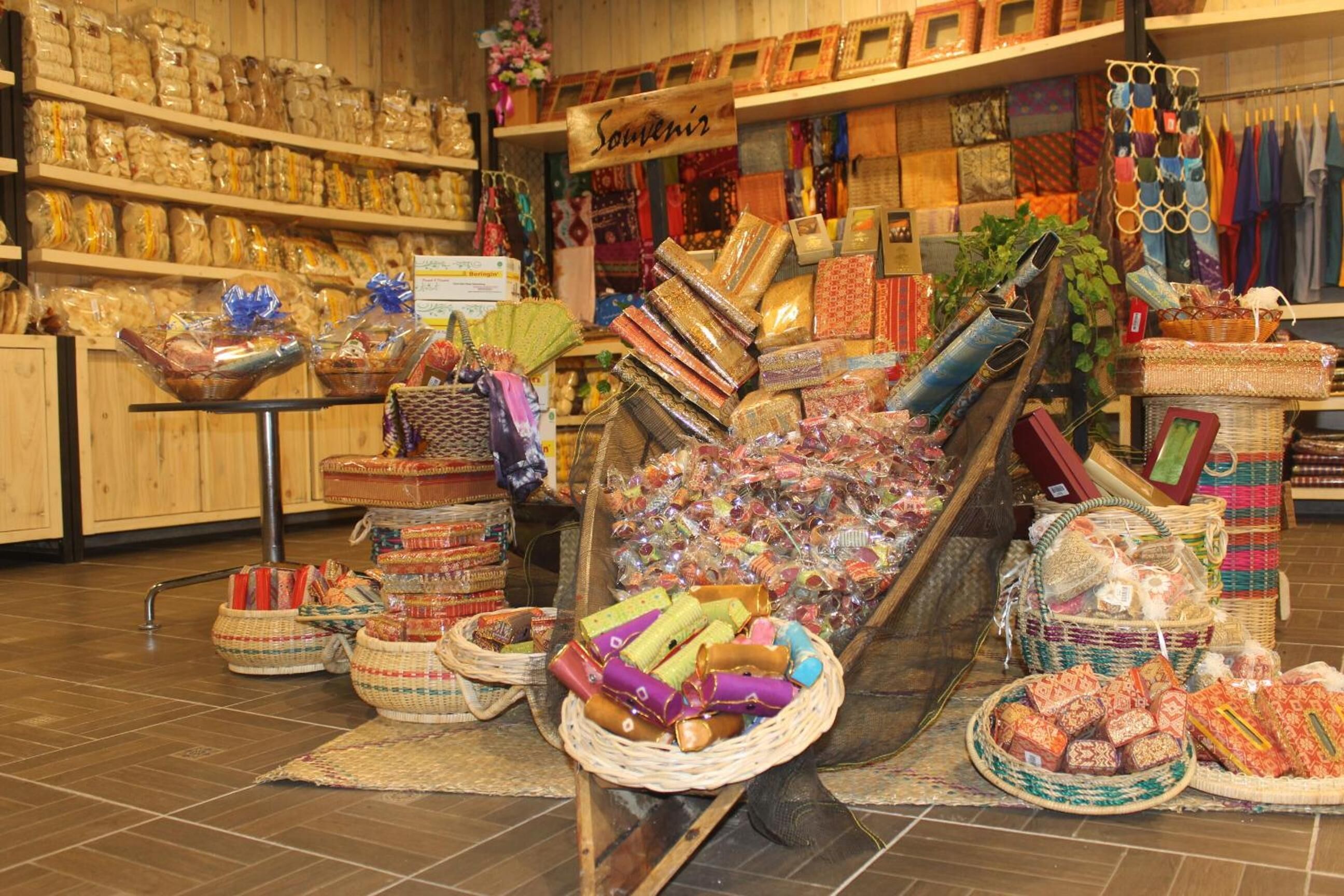 A souvenir shop with various items on display, including woven baskets, textiles, and trinkets.