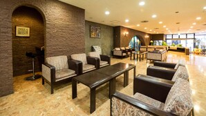 A lobby with seating areas, a reception desk, and a large window. - Hotel Matsunoka Ichinoseki (Ichinoseki)