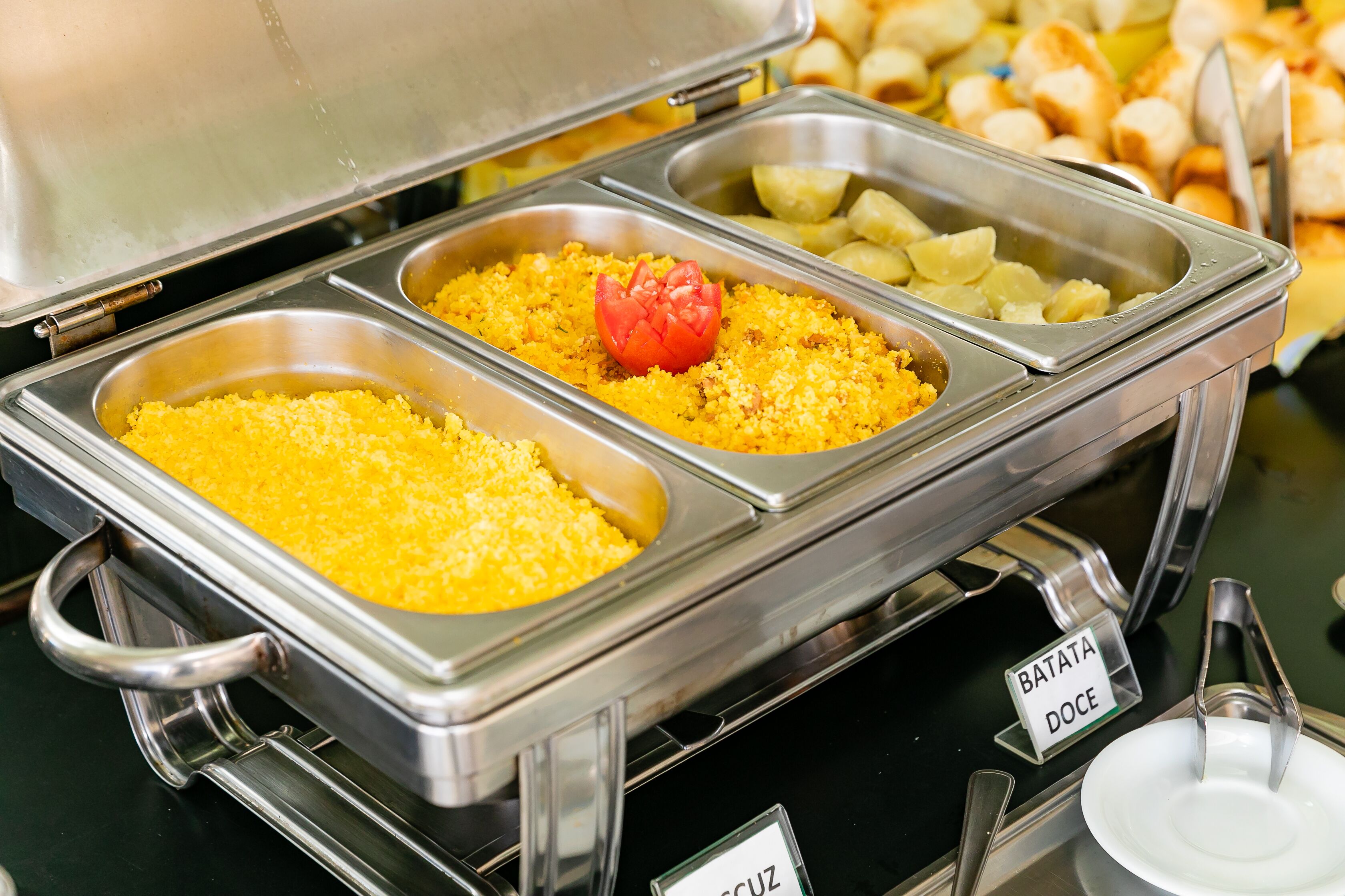 A buffet with labeled sections for different food items.