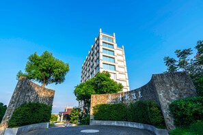 Edifici modern amb façana de vidre i un pati amb un dibuix circular al terra.