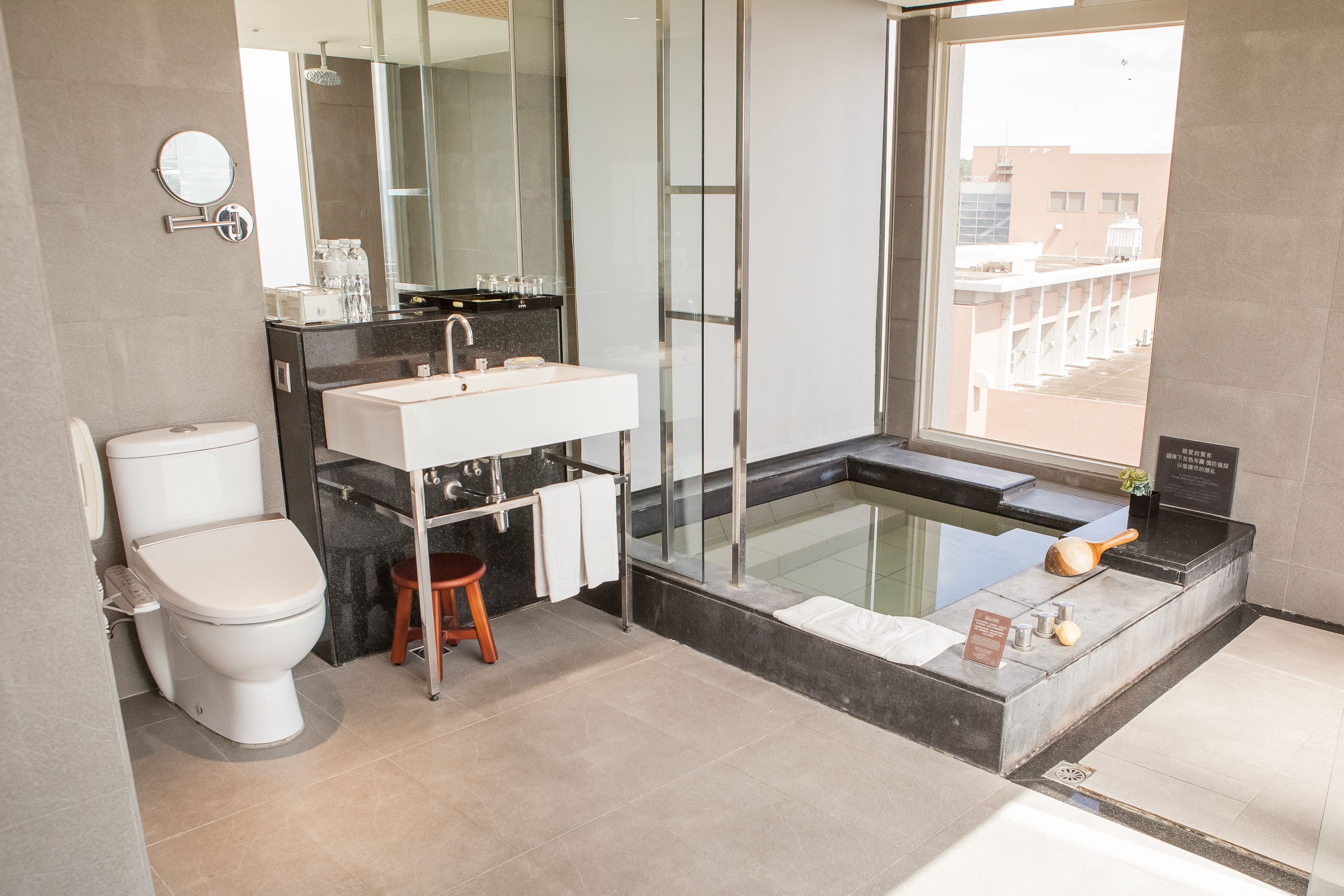 A modern bathroom with a toilet, sink, and bathtub.