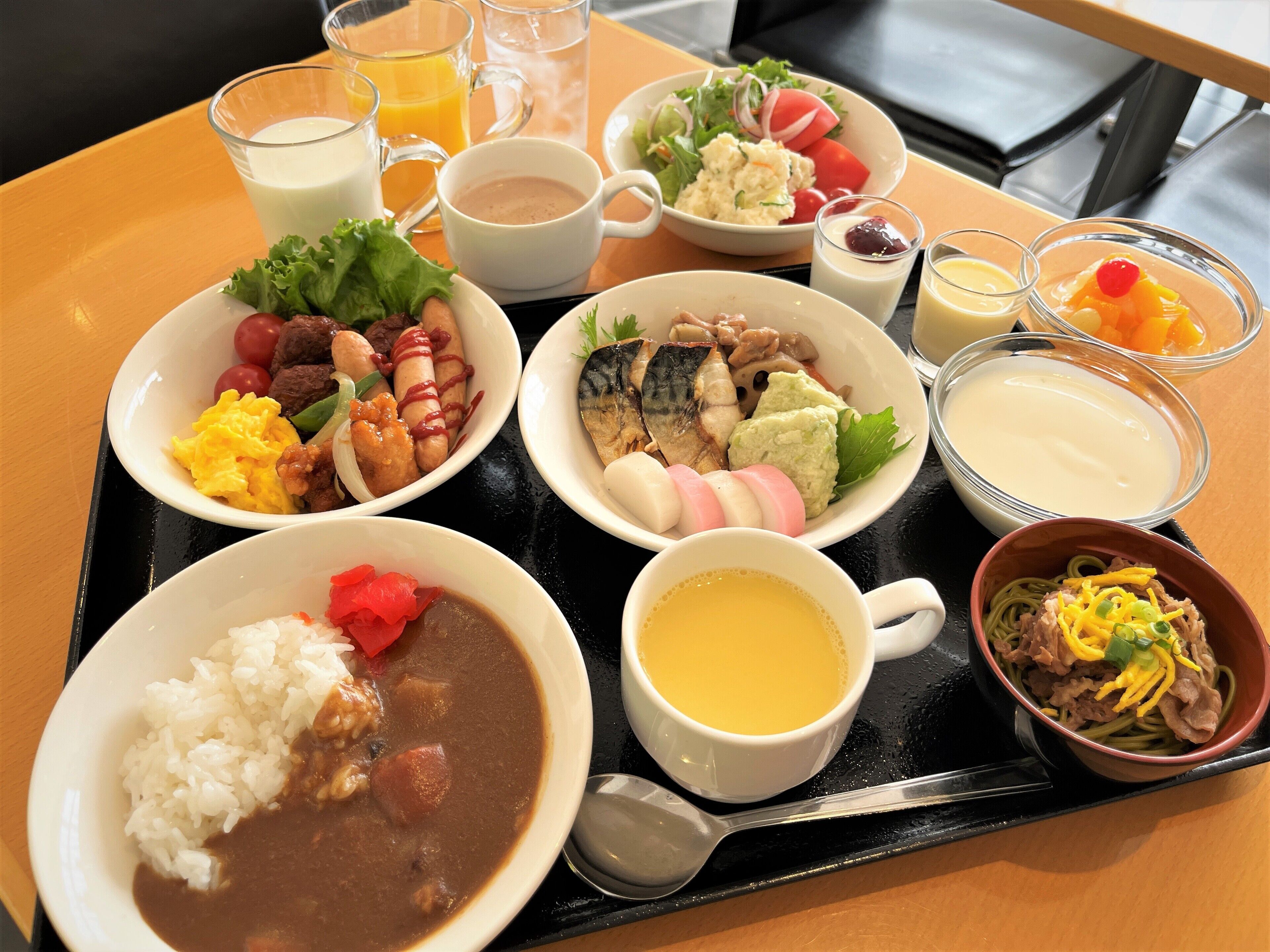 A tray with various dishes including rice, soup, and a salad.