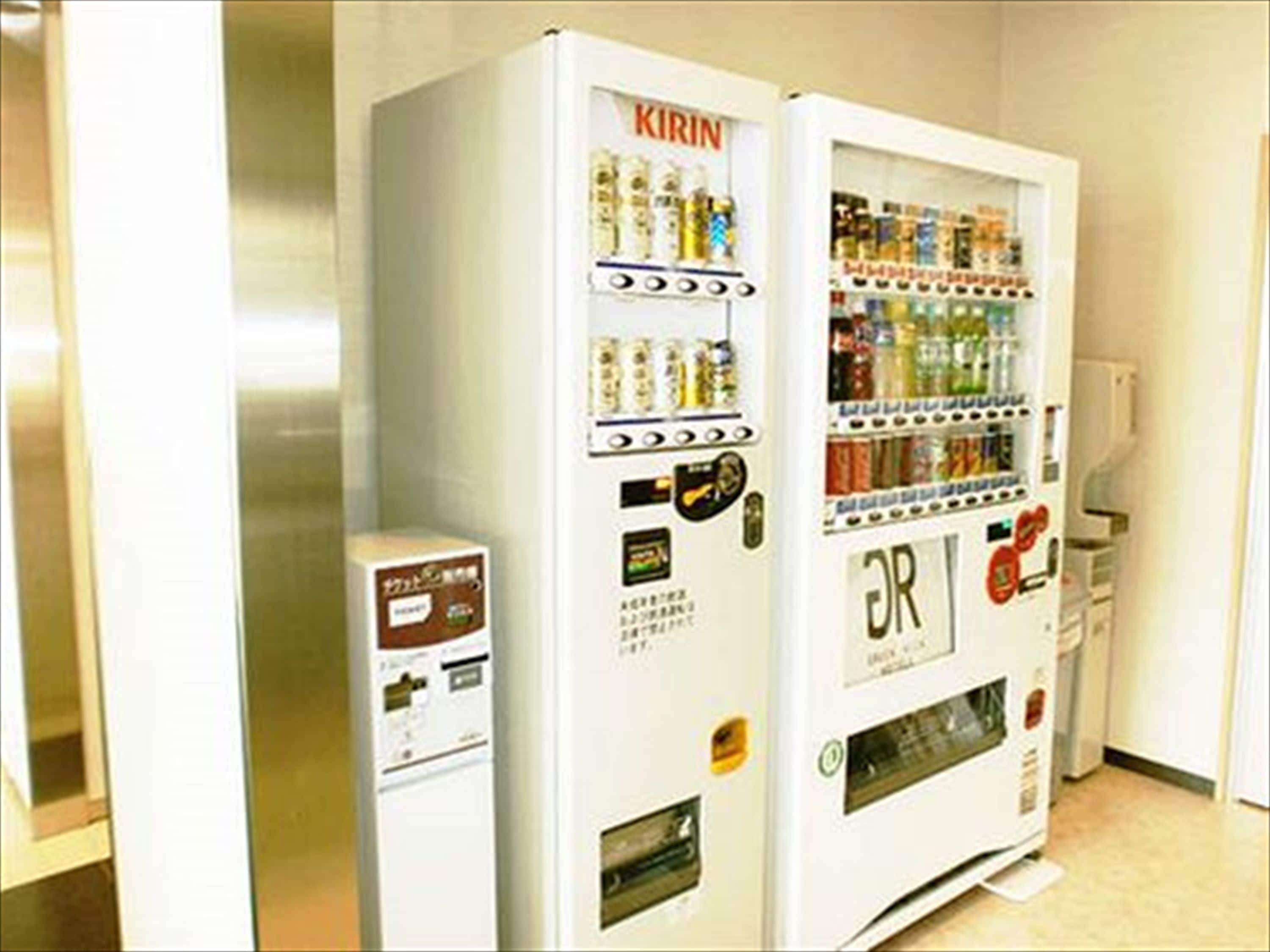 Two vending machines in a hallway.