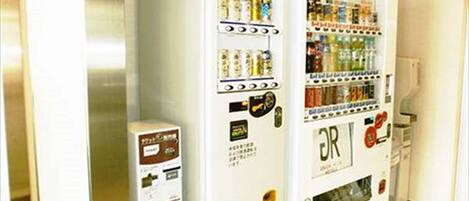 Two vending machines in a hallway.