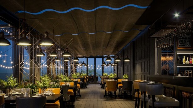 An indoor restaurant with wooden floors, tables with chairs, hanging pendant lights, and a bar area with bottles. - Hotel Sapa Square, Affiliated by Meliá (Sa Pa)