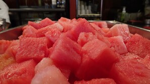 A close-up of cubed watermelon in a metal container. - Hotel El Dorado Hermosillo (Hermosillo)