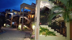 A multi-story hotel with a central courtyard, balconies, and a staircase. - Aparta-Hotel Villa Baya (San Rafael del Yuma)