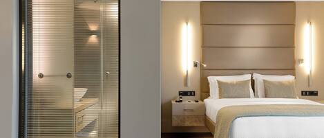 A modern bedroom with a bed, bedside tables, and wall-mounted lighting.