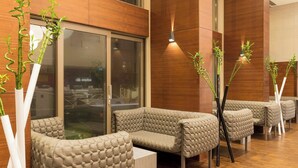 A modern lobby with seating areas, large windows, and wooden flooring. - AC Hotel Istanbul Macka (Istanbul)