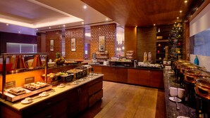 A buffet setup with various food items and a coffee station. - Best Western Country Woods Ambala (Shahabad)