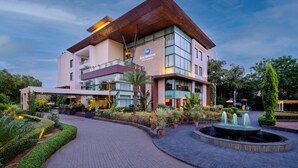 A modern hotel with a prominent 'Best Western' sign, featuring a courtyard with a fountain and well-maintained landscaping. - Best Western Country Woods Ambala (Shahabad)