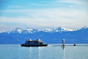 A large cruise ship with multiple decks and a lighthouse in the background. - Holiday Inn Express Friedrichshafen by IHG (Friedrichshafen)
