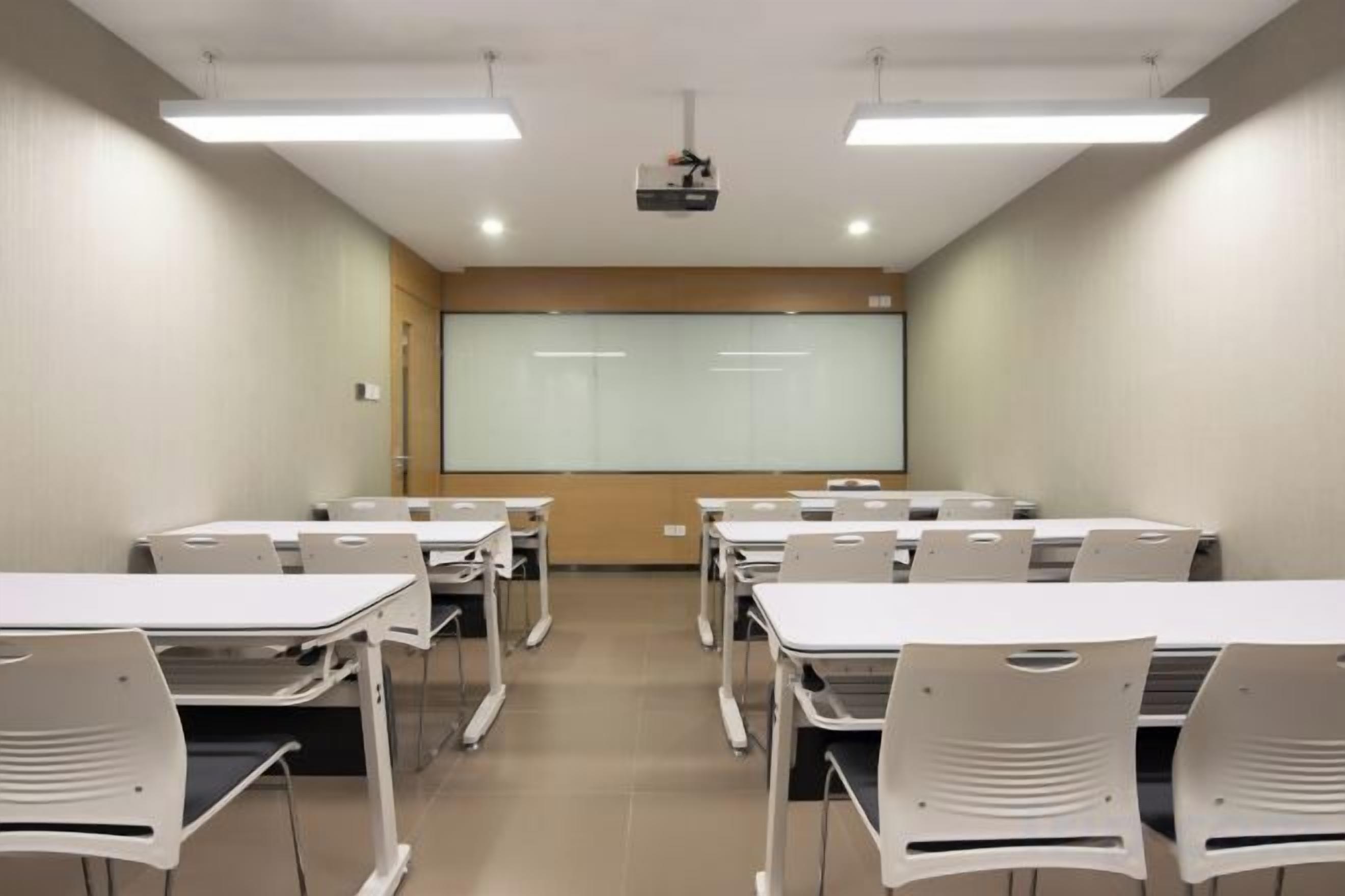 A conference room with tables and chairs arranged for a meeting.