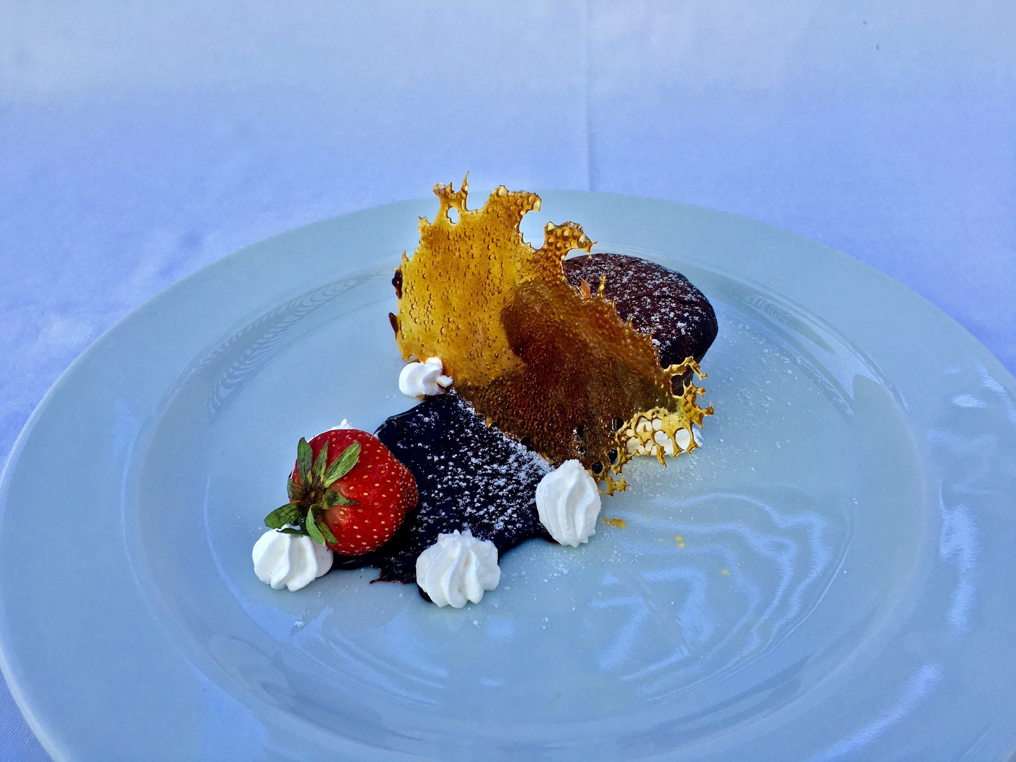 A dessert on a plate with a blue background.