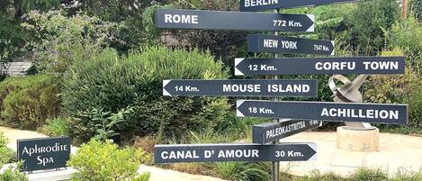A directional signpost with distances to various cities and locations.