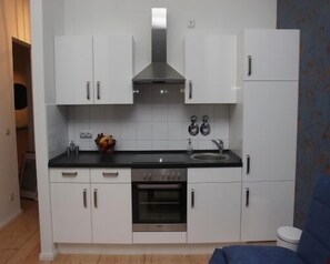 Apartment, 1 Bedroom | Private kitchen | Full-sized fridge, stovetop, coffee/tea maker, high chair