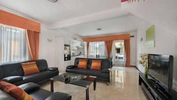 Deluxe Apartment, 1 Bedroom | Living area | Flat-screen TV
