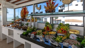 A buffet counter with various food items and a scale for weighing. - SERHS Beach Hotel (Natal)