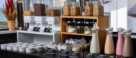 A breakfast bar with various food items and condiments.