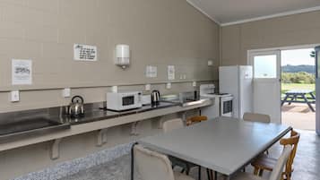 Mini-fridge, electric kettle, toaster, cookware/dishes/utensils