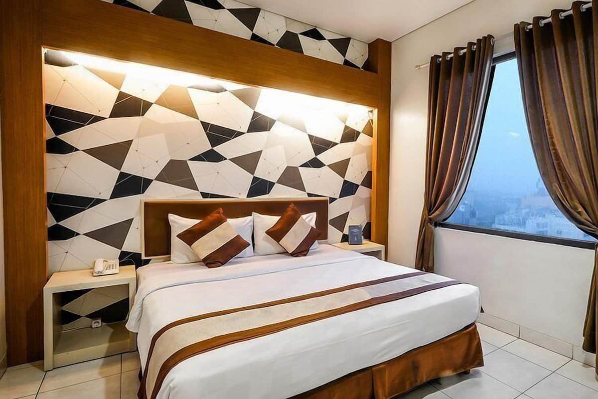 A modern hotel room with a geometric-patterned headboard, a neatly made bed with brown and white bedding, a bedside table with a phone, and a window with curtains.