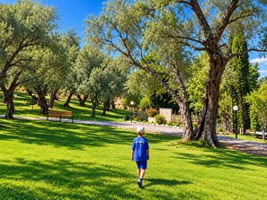 A park with walking paths, benches, and trees. - Hotel Yannis Corfu (Corfu)
