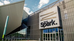 A modern building with a prominent sign reading "TELUS Spark." - Hotel Clique Calgary Airport (Calgary)