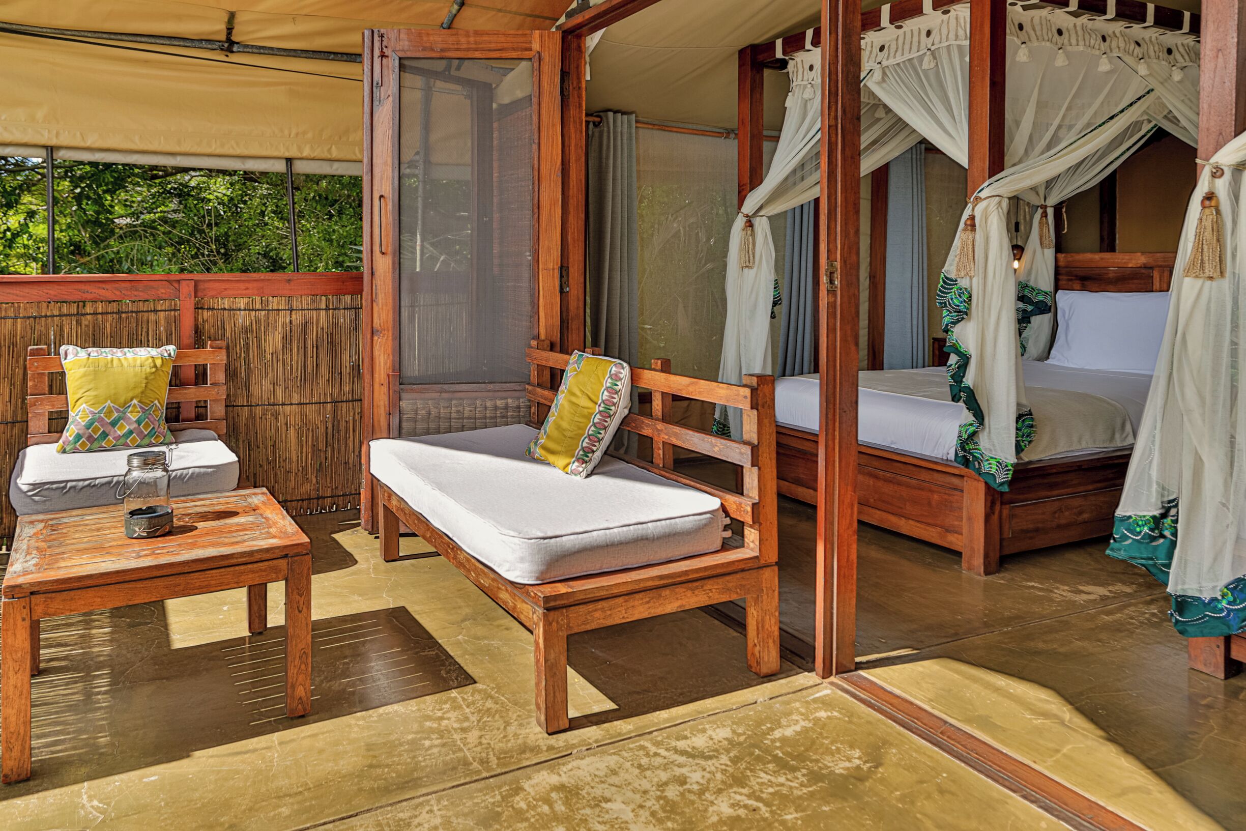 A wooden room with a bed, a bench, and a table.