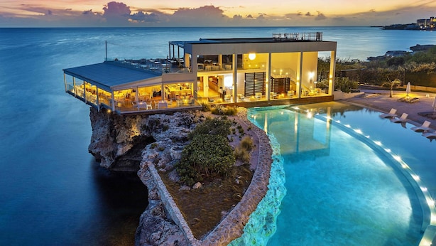 A modern hotel with a pool on a rocky outcrop, overlooking the sea. - Sonesta Ocean Point All Inclusive, Adults Only Resort (Lowlands)