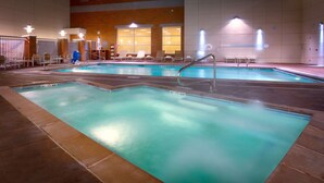 An indoor swimming pool with multiple lanes, lounge chairs, and a changing room area. - Hyatt House Salt Lake City Downtown (Salt Lake City)