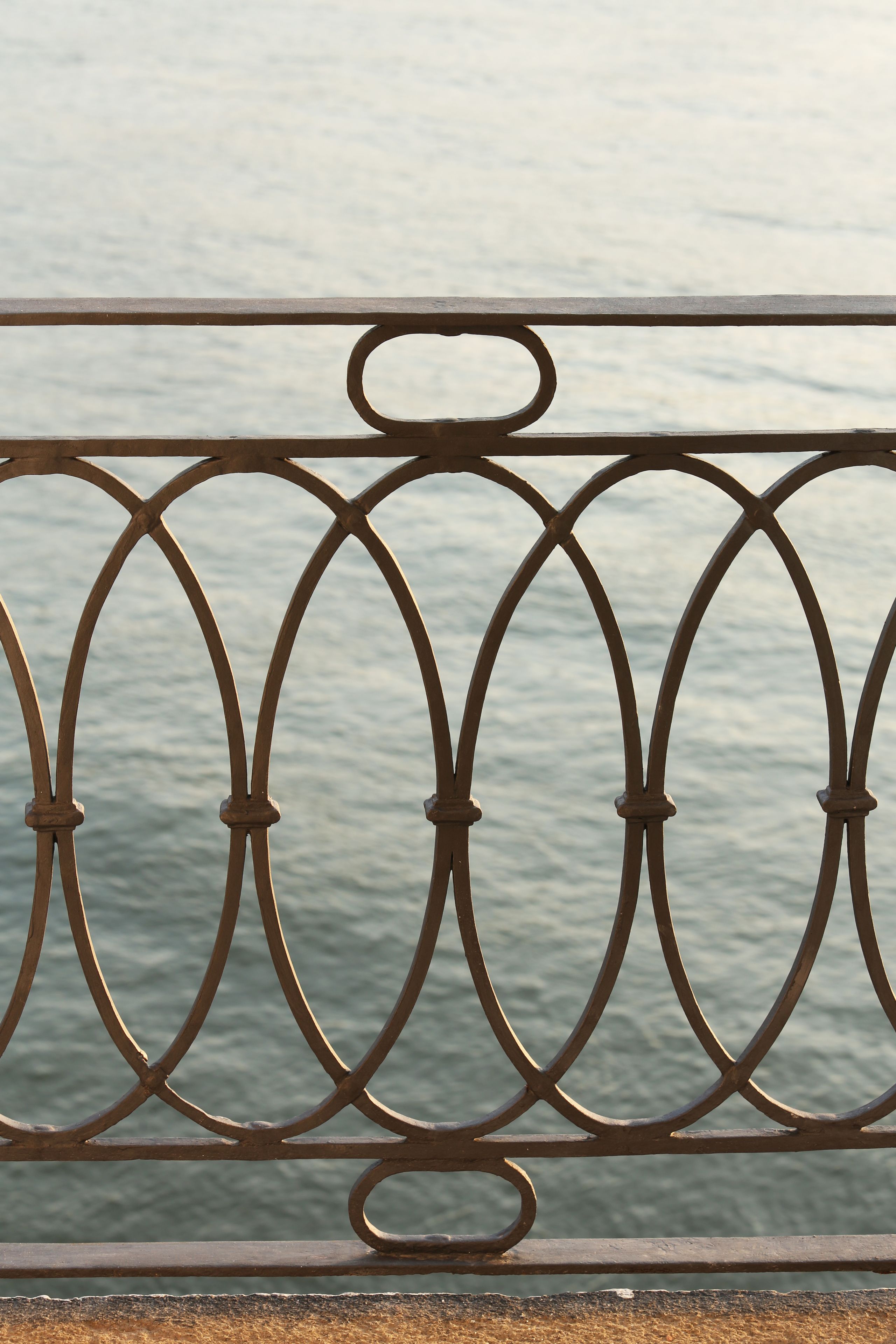 A metal railing with a decorative pattern.