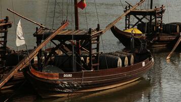 A wooden boat with the name "DOURO" docked at a pier.