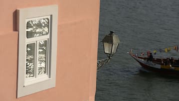 A building with a window and a wall-mounted lamp.