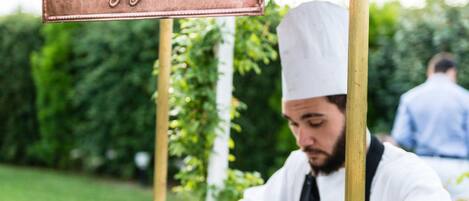 A chef preparing food at an outdoor food station named "Friggitorium."