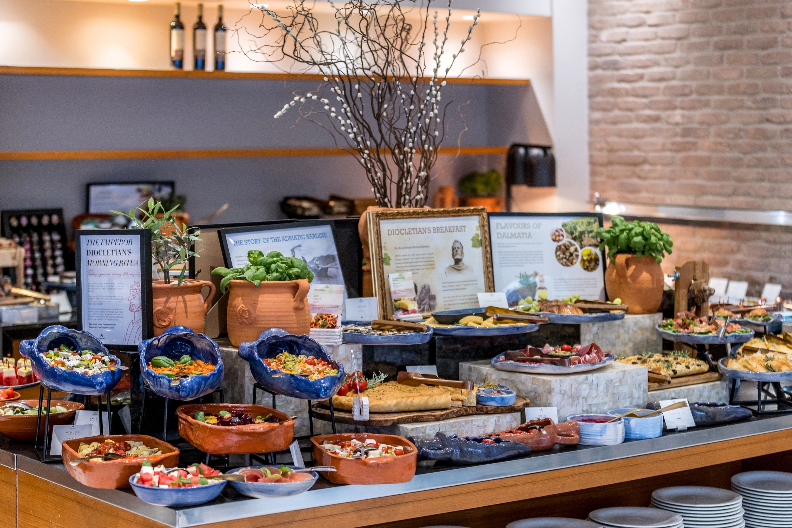 A buffet with various food options and informational signs.