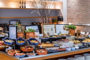A buffet with various food options and informational signs.
