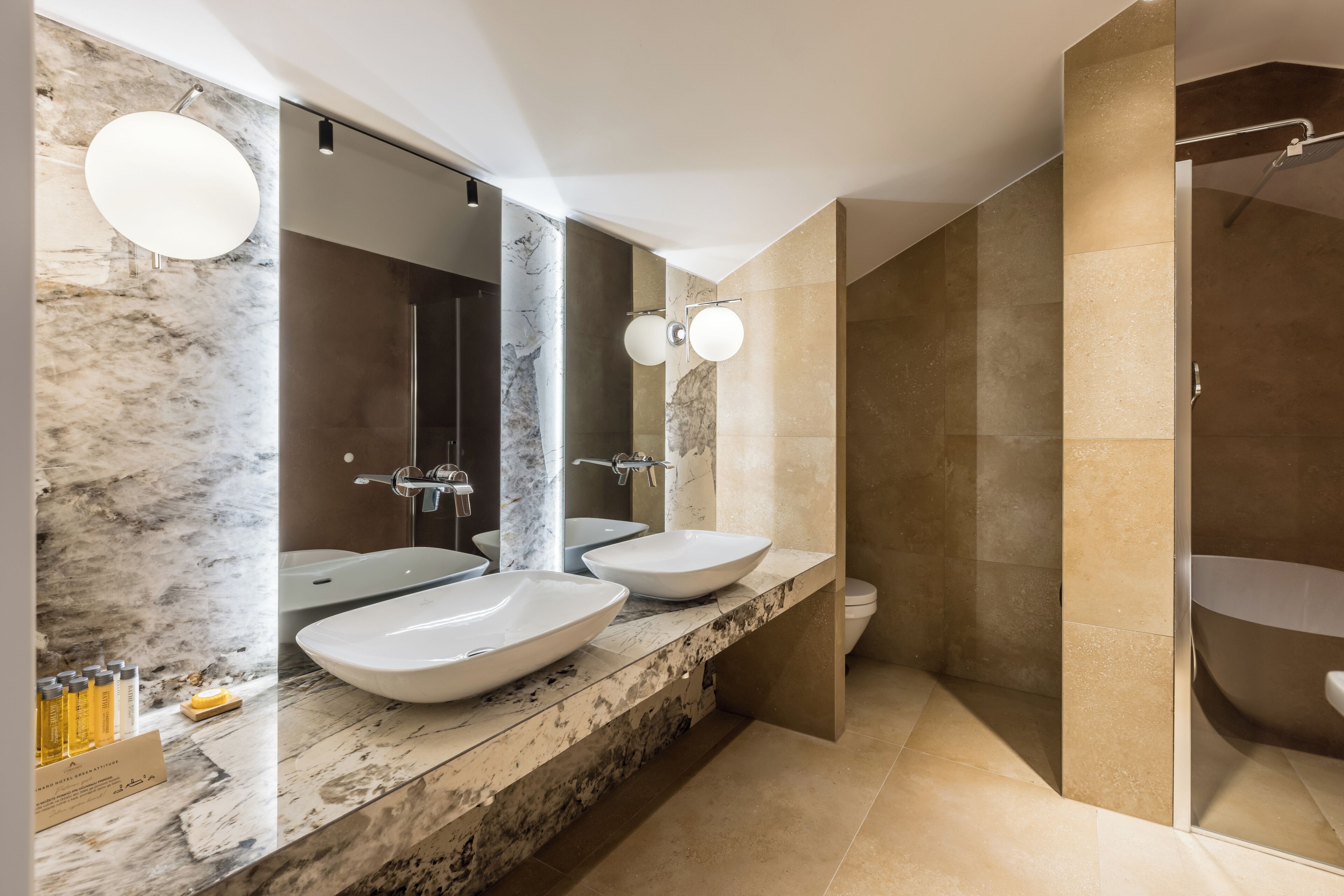 deluxe studio suite, 1 king bed | bathroom | rainfall showerhead, designer toiletries, hair dryer, towels