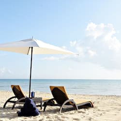 On the beach, white sand, sun-loungers, beach umbrellas