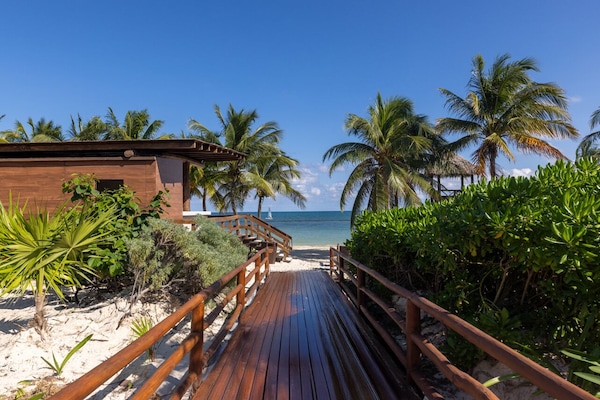 On the beach, white sand, sun loungers, beach umbrellas