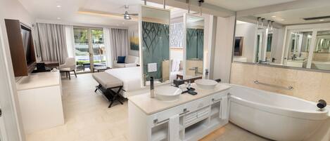 A modern bathroom with a large bathtub, two sinks, and a large mirror.