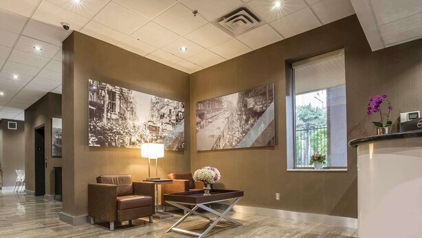A lobby with a reception desk, seating area, and large wall art. - The Saint James Hotel, an Ascend Collection Hotel (Toronto)