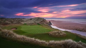 A golf course with a view of the beach and ocean at sunset. - Trump® International Scotland (Aberdeen)