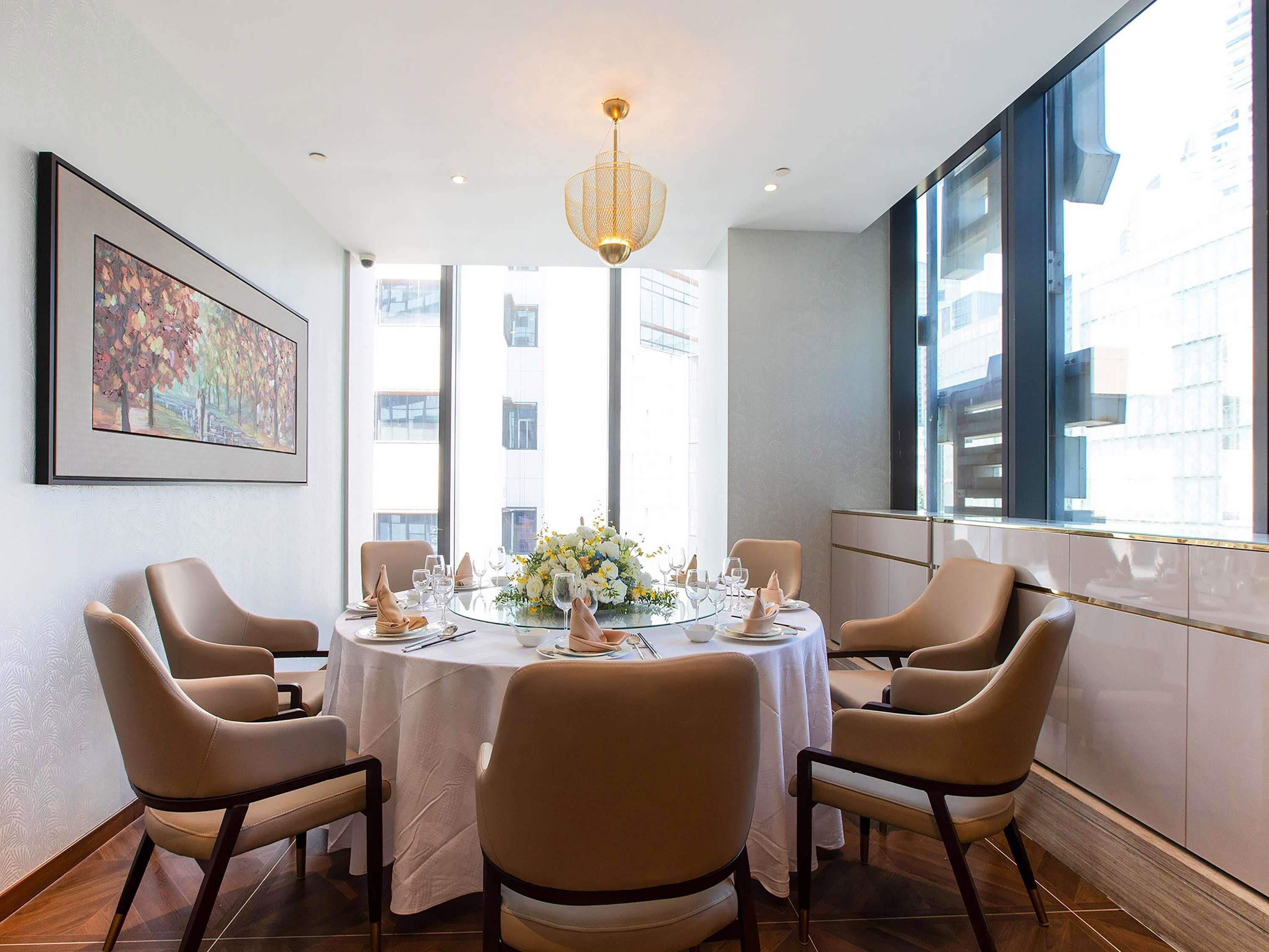 Comedor con una mesa redonda dispuesta para seis personas, rodeada de seis sillas.