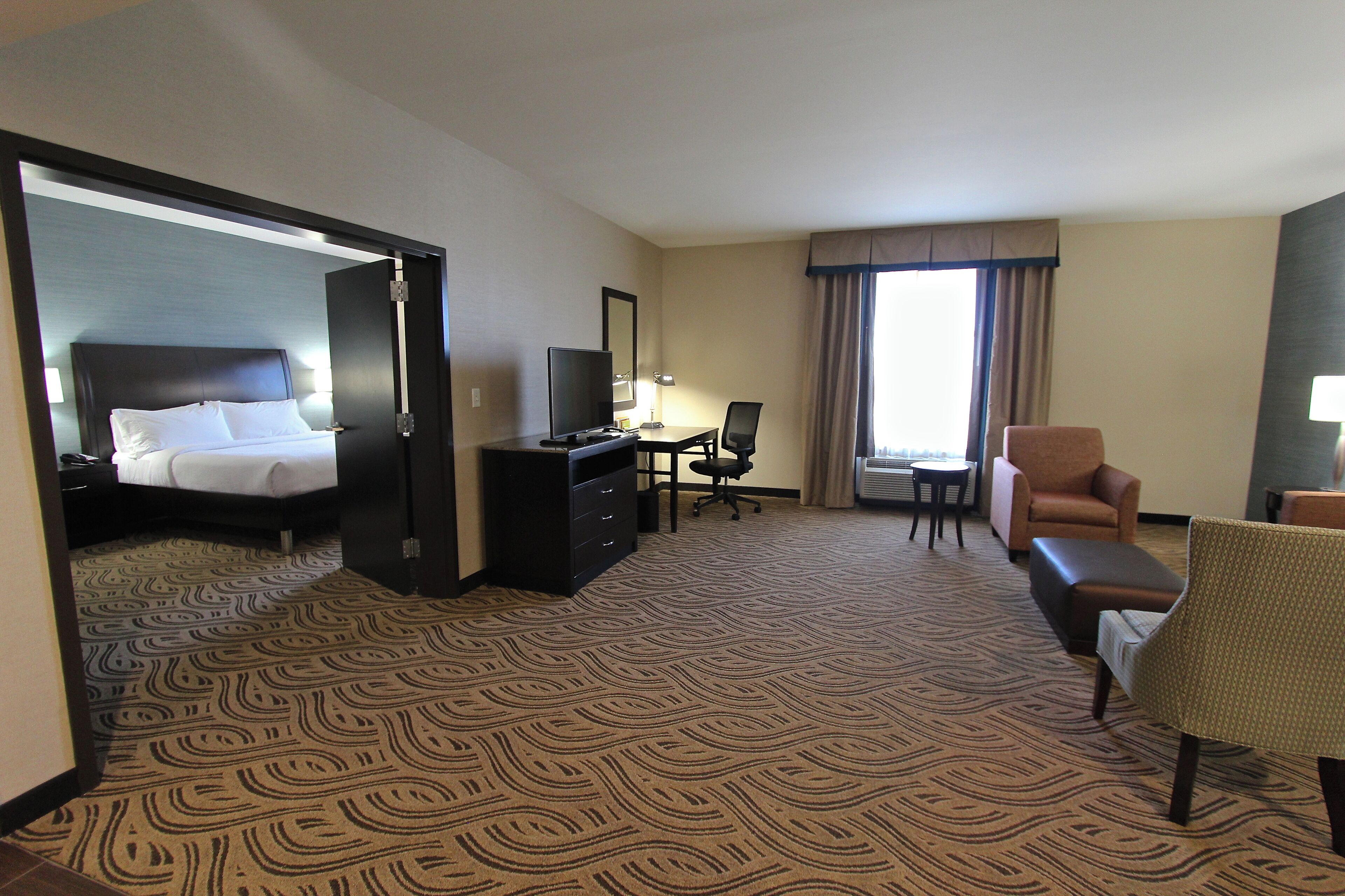 Premium bedding, desk, laptop workspace, blackout drapes