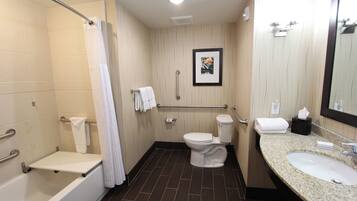 A modern bathroom with a bathtub, toilet, and sink.