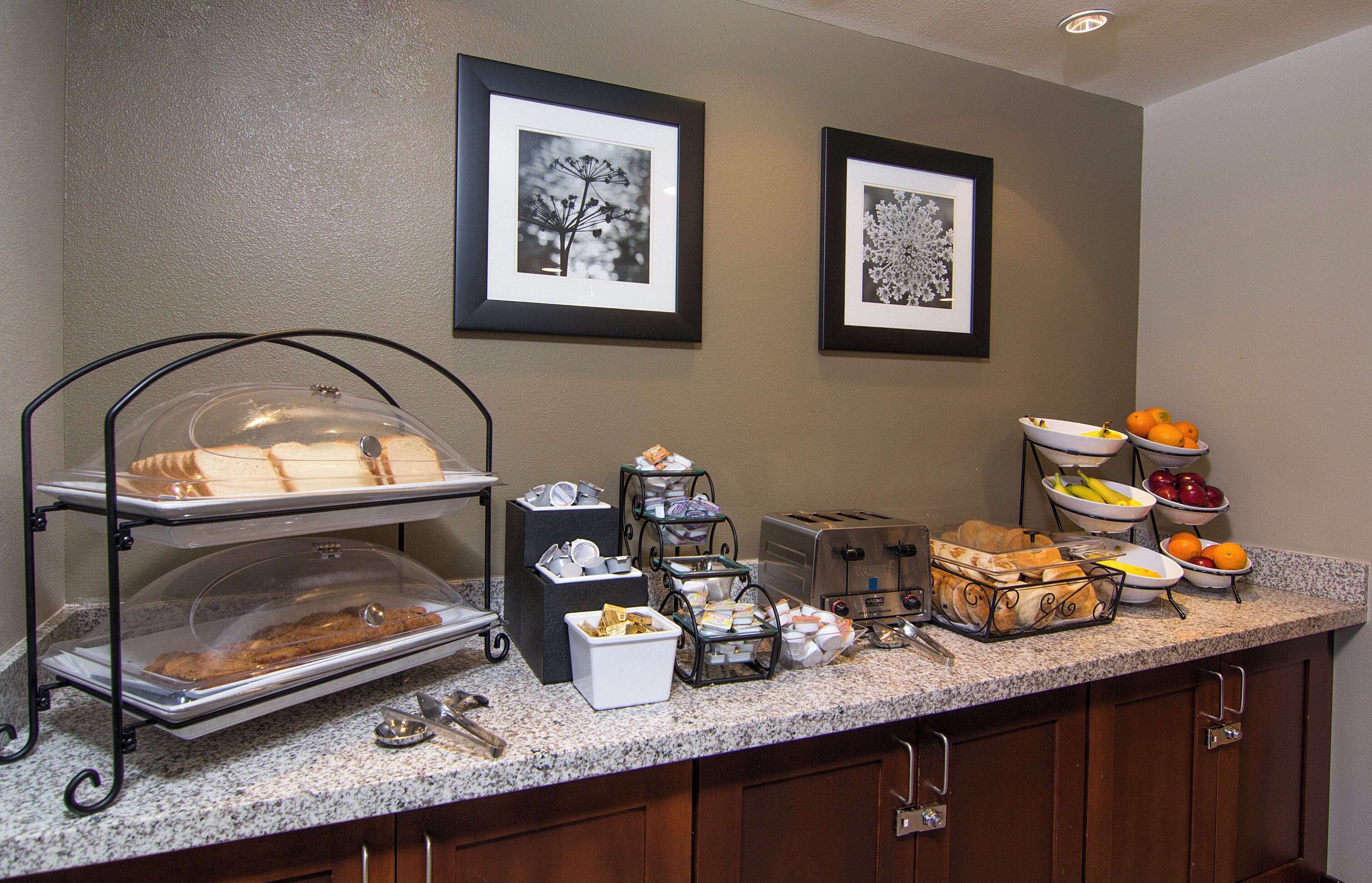 A breakfast buffet setup with various food items and a toaster.