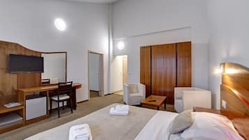 Family Quadruple Room | Minibar, in-room safe, desk, laptop workspace