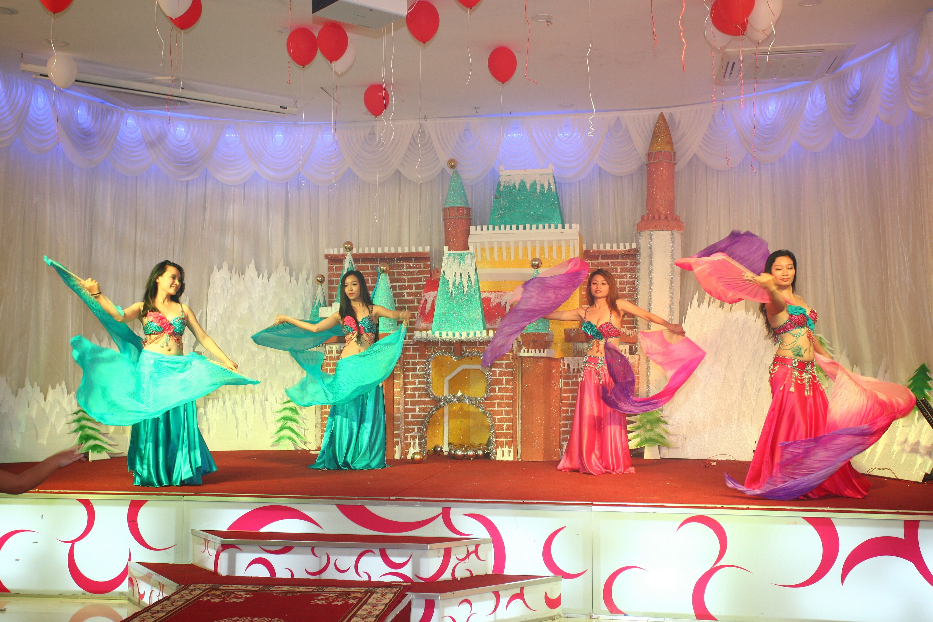 A stage with performers in colorful costumes.