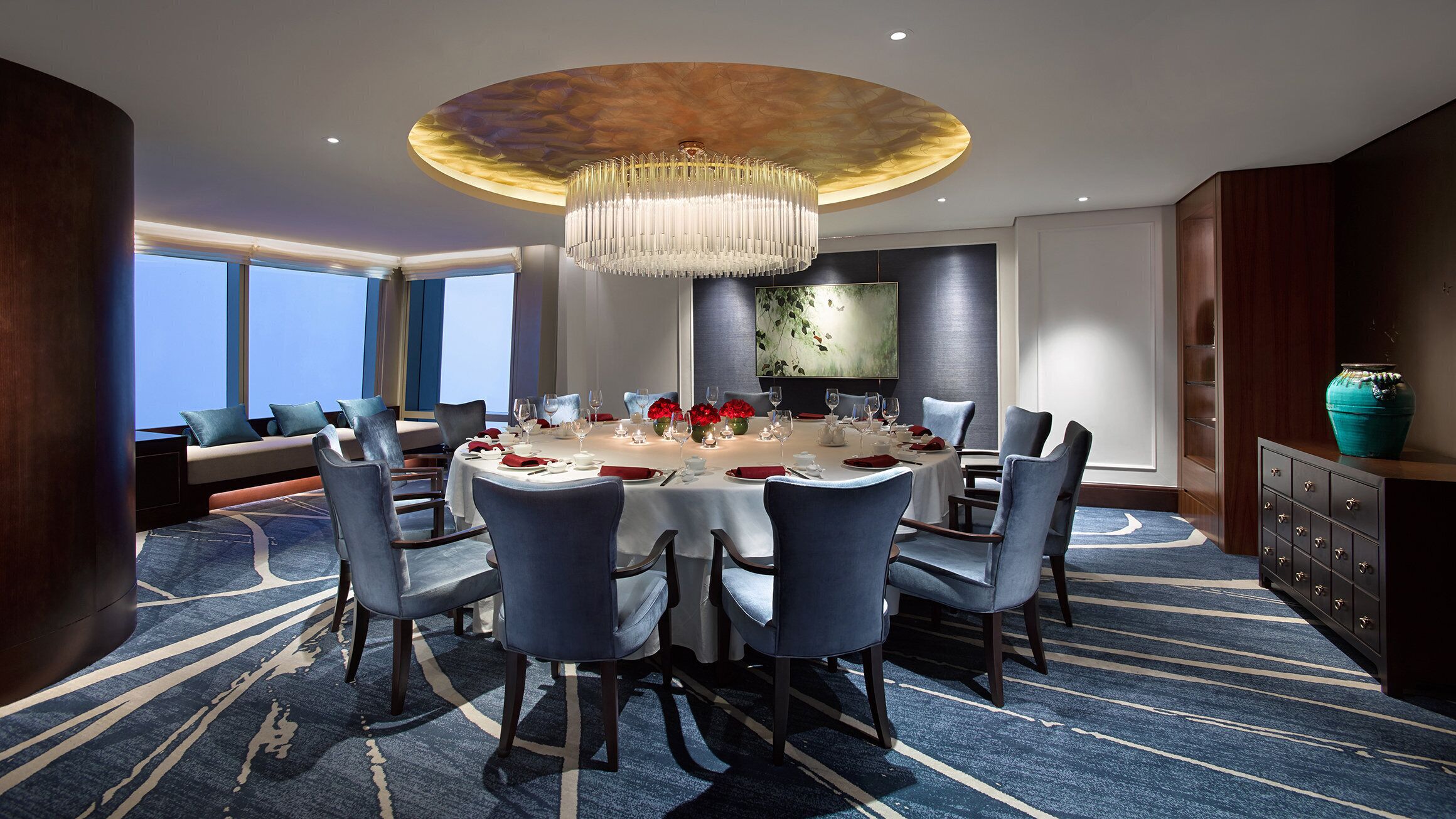 Un comedor con una mesa redonda dispuesta para seis personas, rodeada de seis sillas.